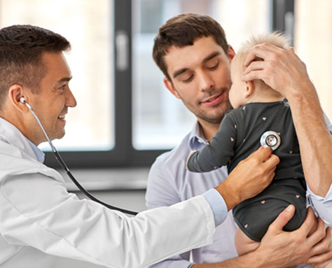 Family Doctor Checking A Babies Heart Beat - Arlington TX